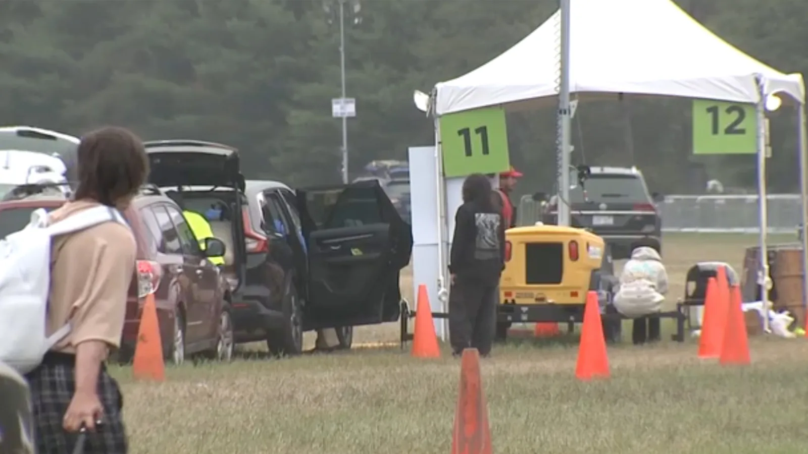 Police and festival officials investigate a portable toilet area at Electric Forest in Michigan