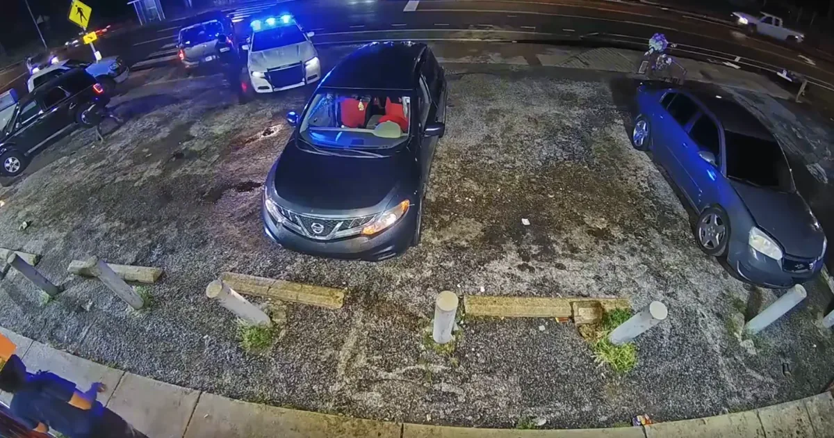 Surveillance video still showing a Memphis Police SUV and a gray vehicle in a parking lot before the shooting