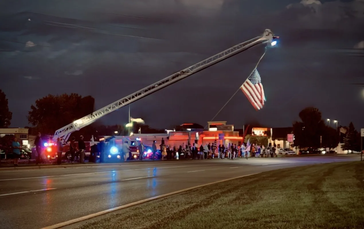 People line Highway 55 in Buffalo to honor Army Specialist Hunter Sandberg during a homecoming motorcade