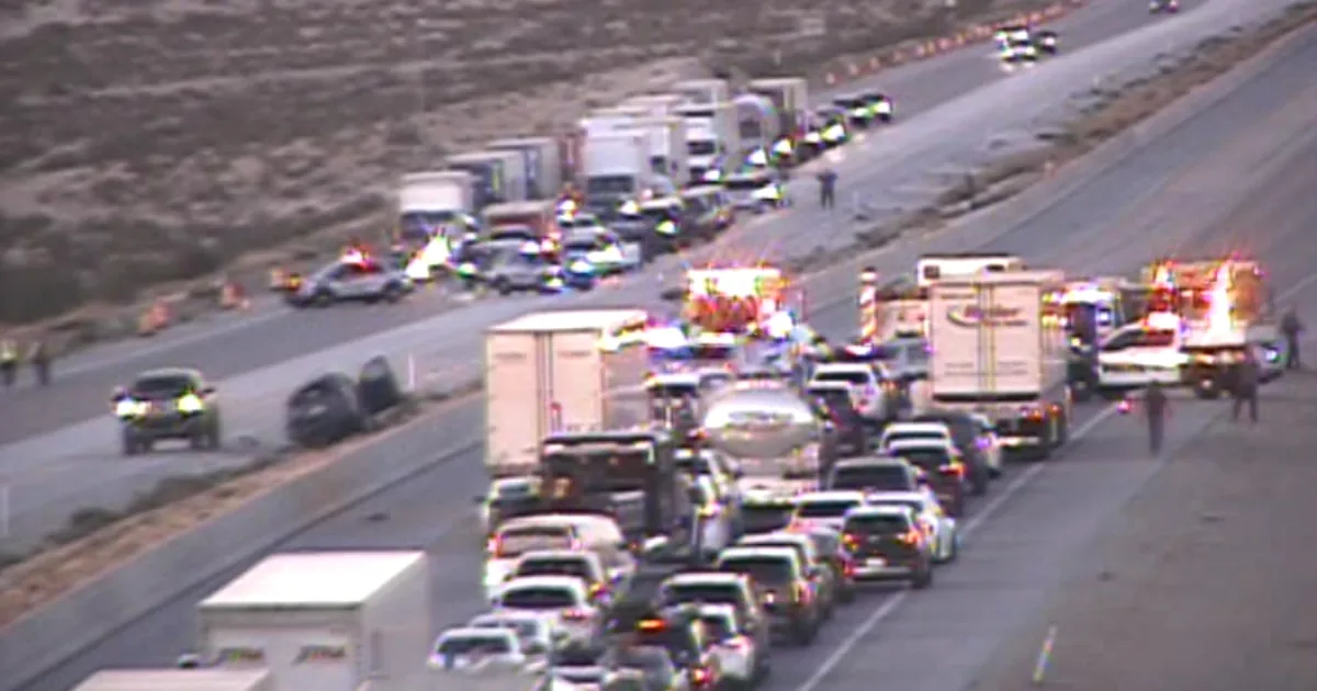 Nevada State Police vehicles near a closed stretch of I-15 after a rollover crash