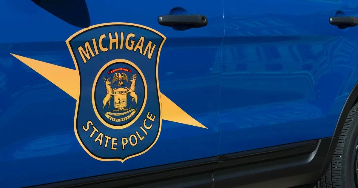 Police lights at a highway crash scene with blocked lanes and emergency responders nearby